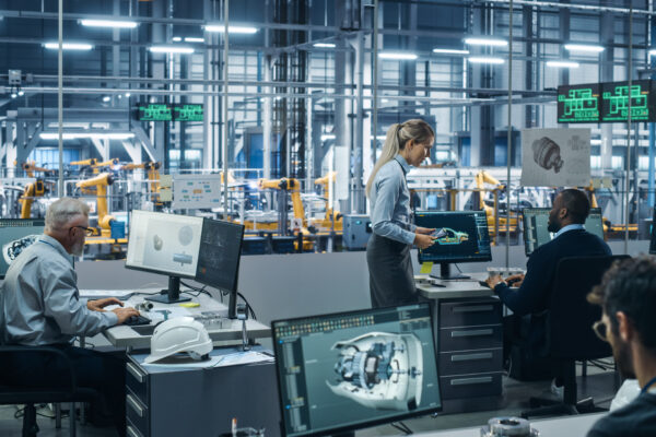 Team of professionals working in a high-tech industrial office, representing The William Stanley CFO Group's feature in GENCFO on CFO automation and digital transformation.