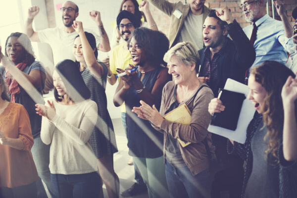Diverse group celebrating together in a bright room, symbolizing The William Stanley CFO Group’s launch press release covered by Cision PRWeb.