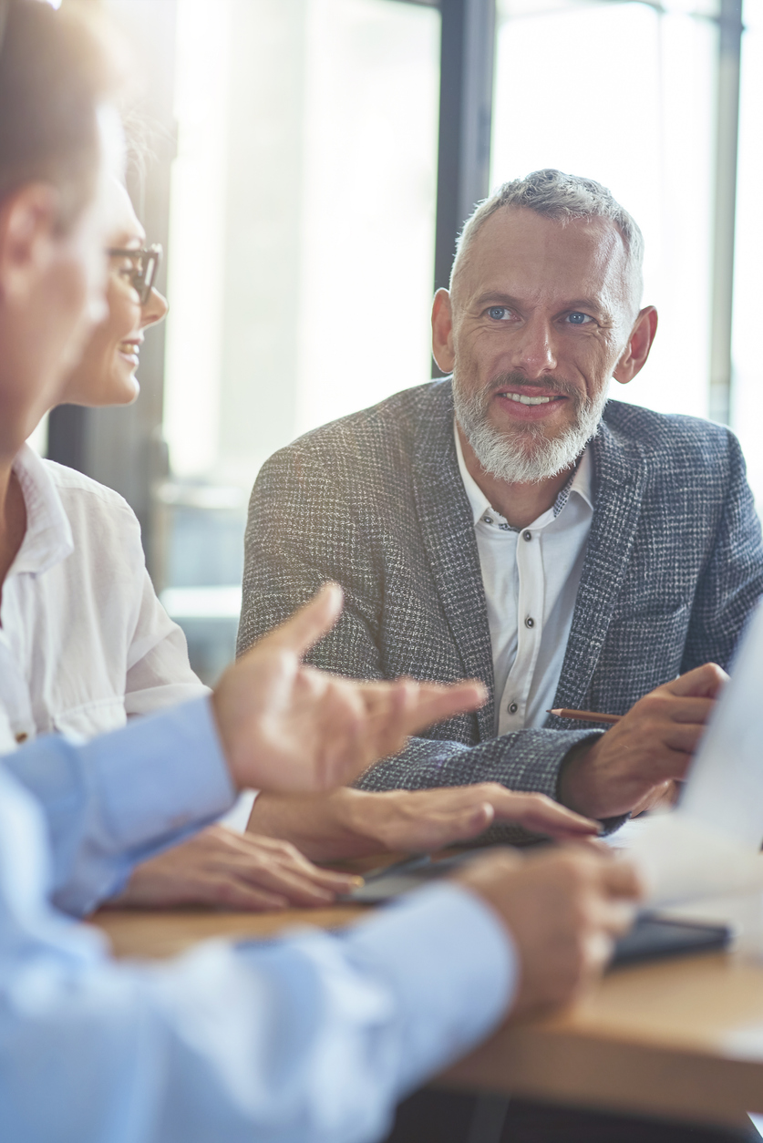 businessman sitting with colleagues in the modern office