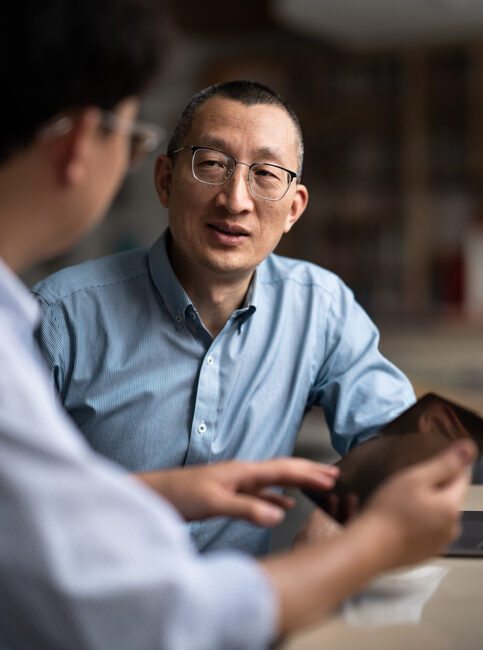 two businessmen in open office